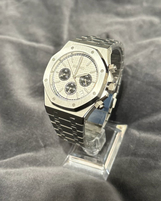 Silver watch on a gray textured background